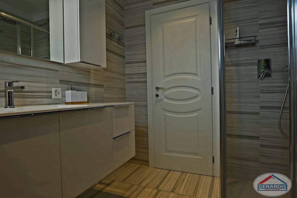 Modernes Badezimmer mit Glastür und Spiegelschrank