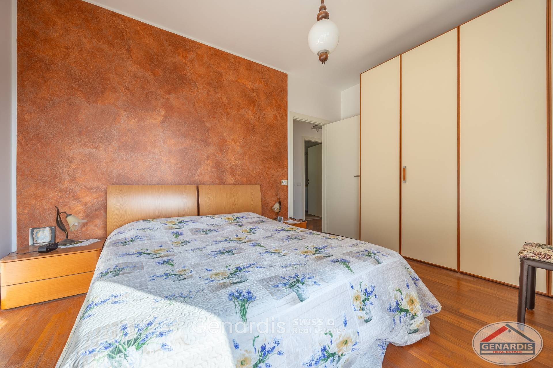 Schlafzimmer mit Holzoptik und großem Einbauschrank