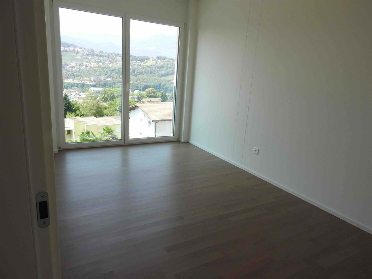 Leeres Schlafzimmer mit Panoramafenster und Bergblick