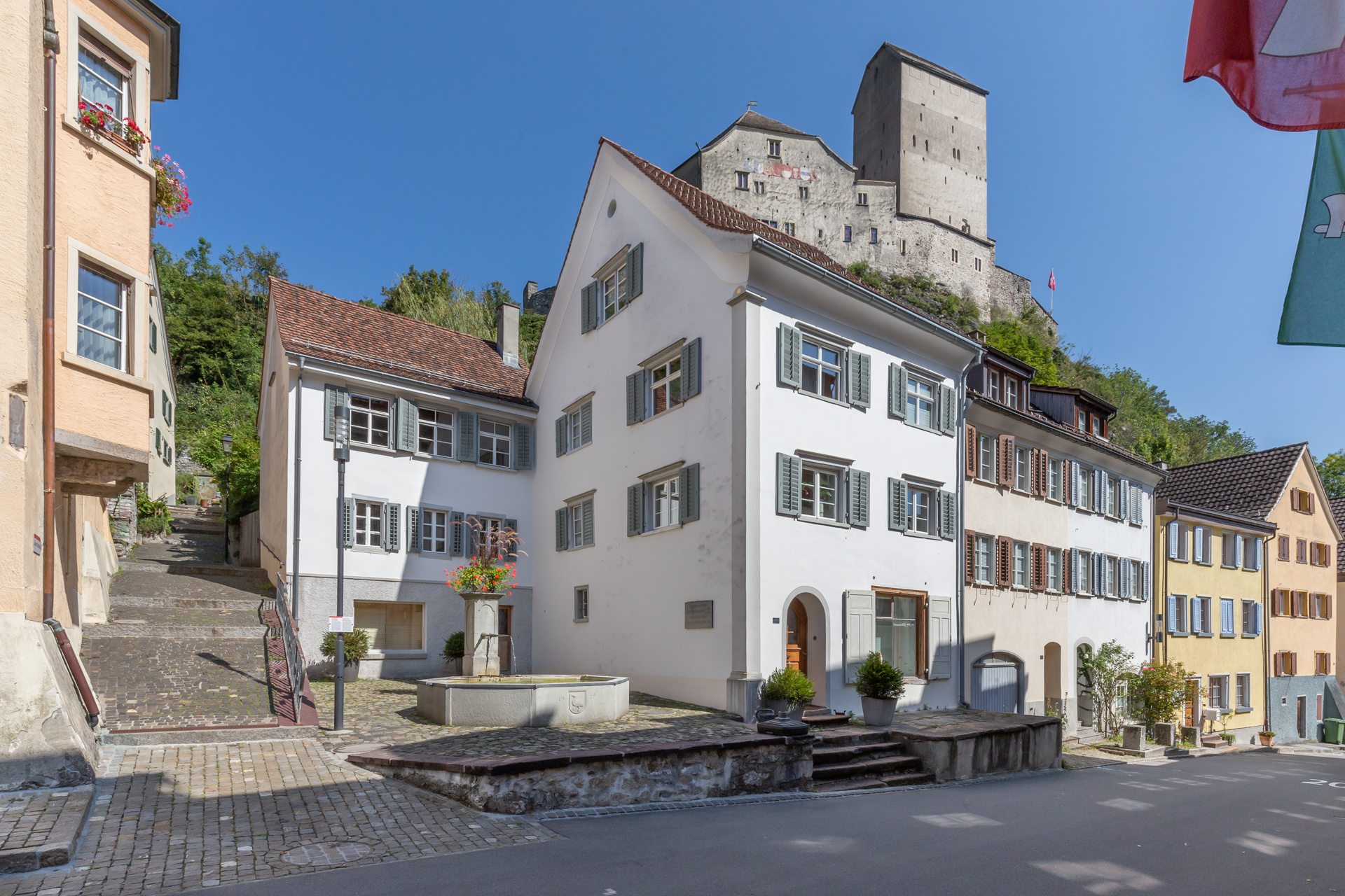 Historische Häuserzeile mit Burg im Hintergrund