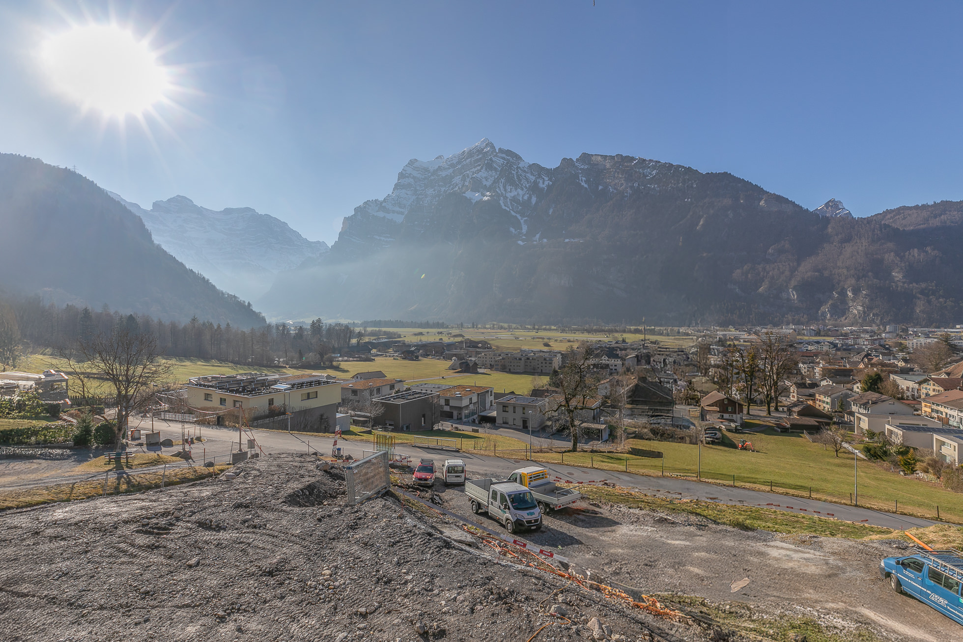Panoramablick auf alpines Tal mit Bergen und Siedlung