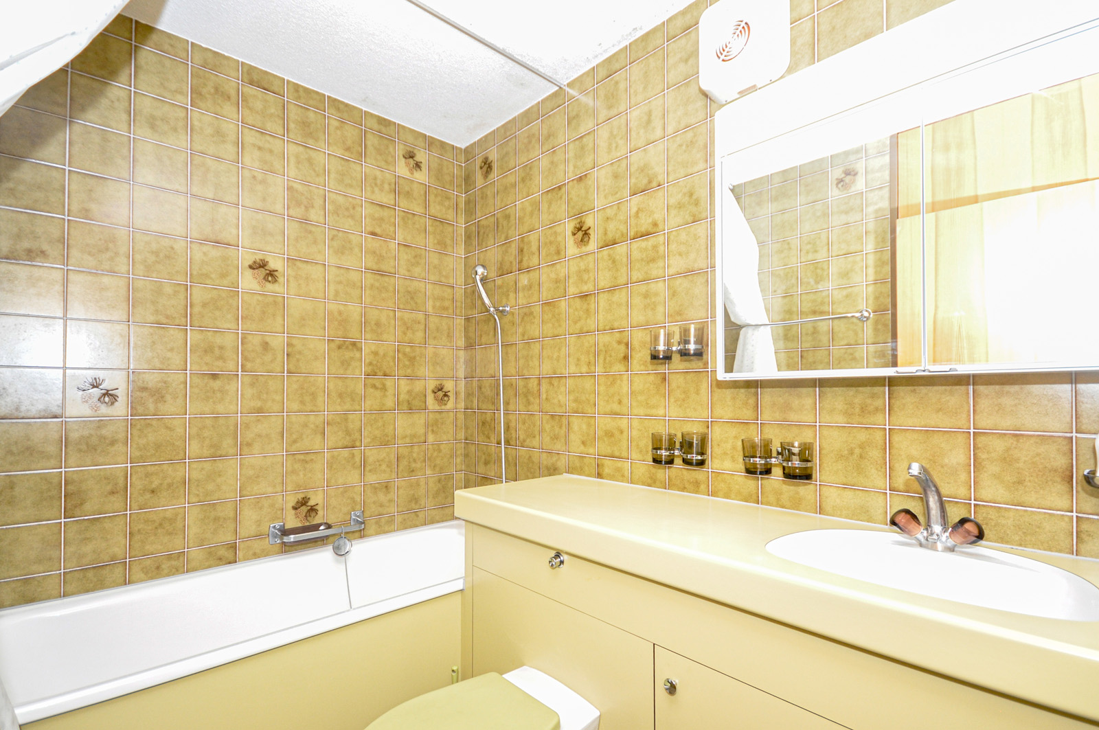 Badezimmer mit gelb-braunen Fliesen