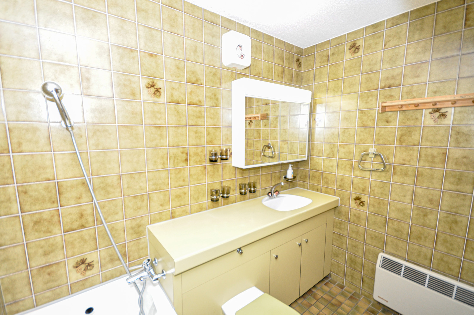 Badezimmer mit gelblicher Fliesenoptik