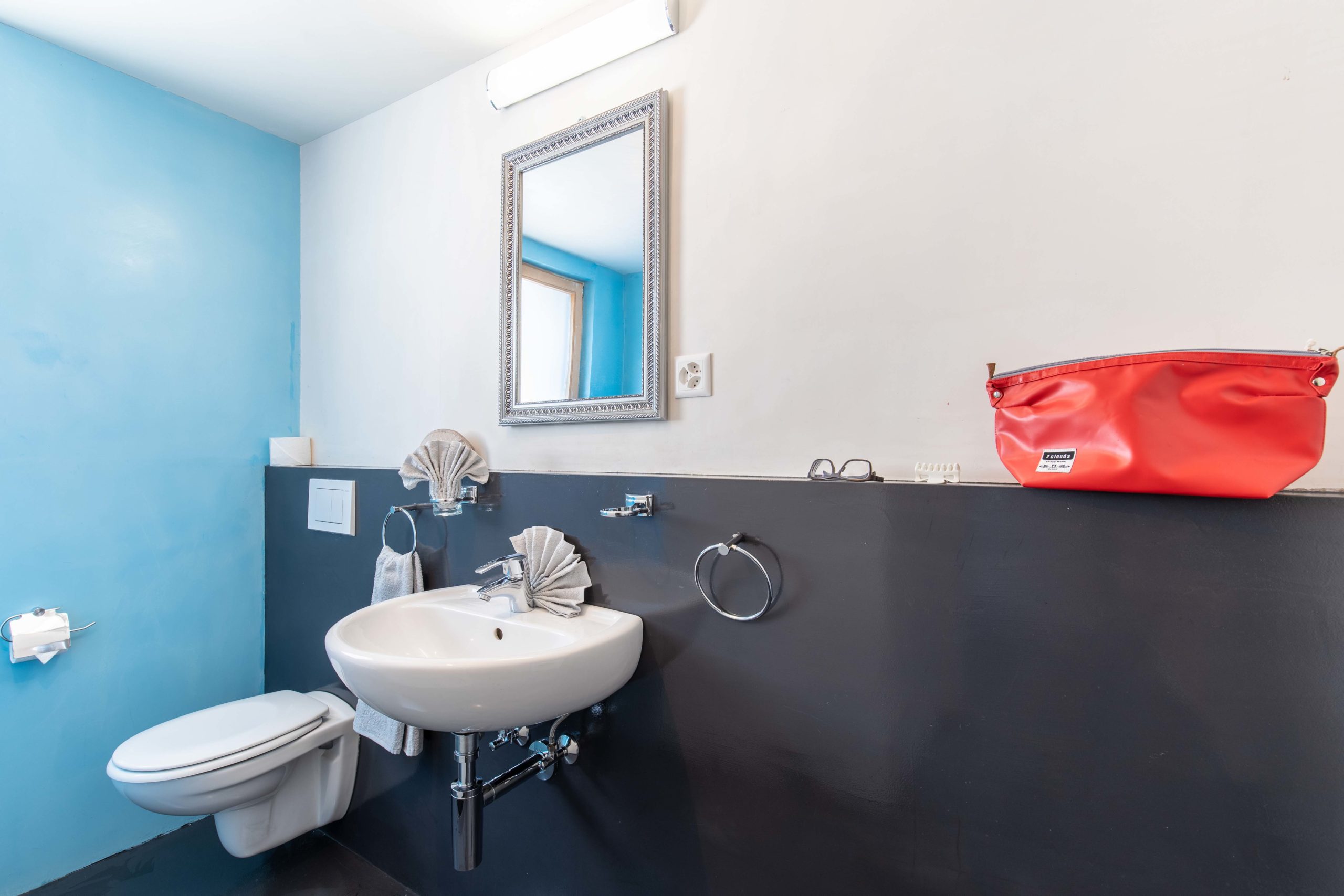Kleines Gästebad mit blau-weißer Wandgestaltung