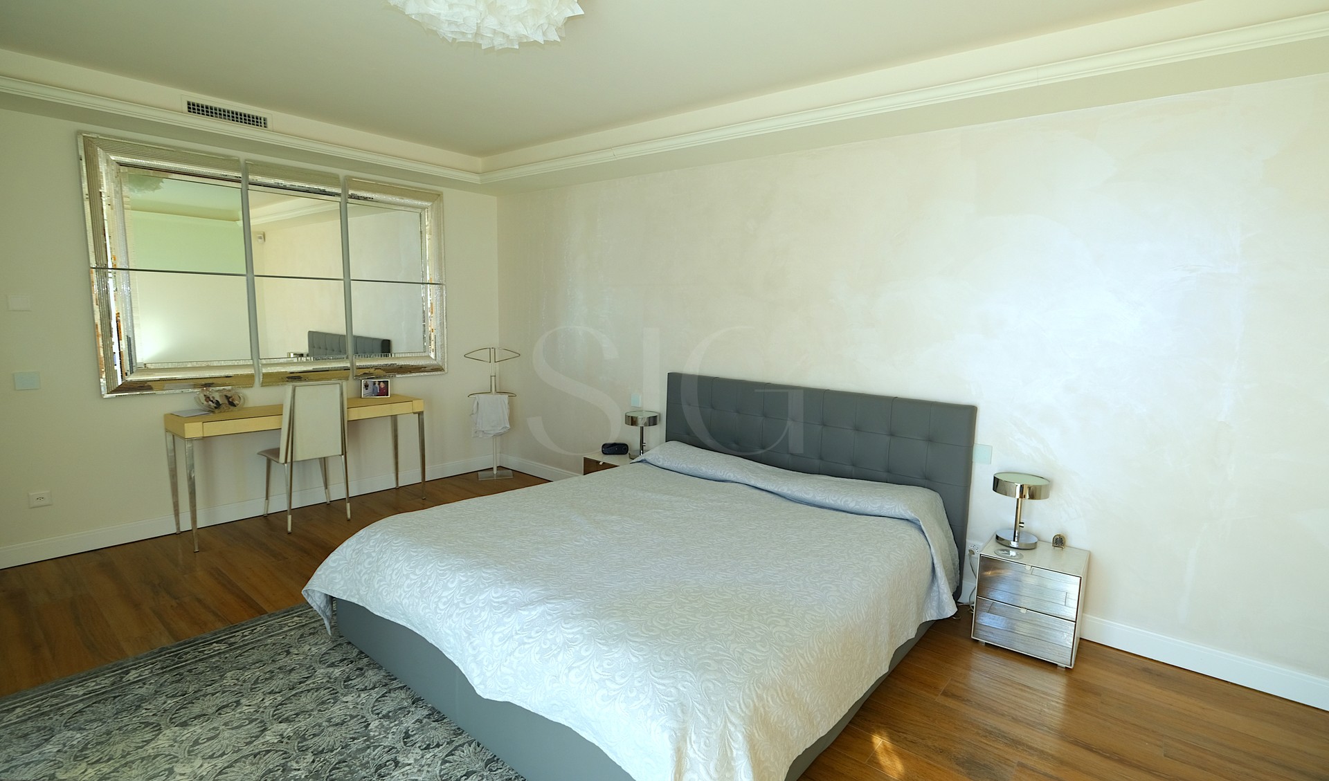 Modernes Schlafzimmer mit großem Bett und Schminktisch
