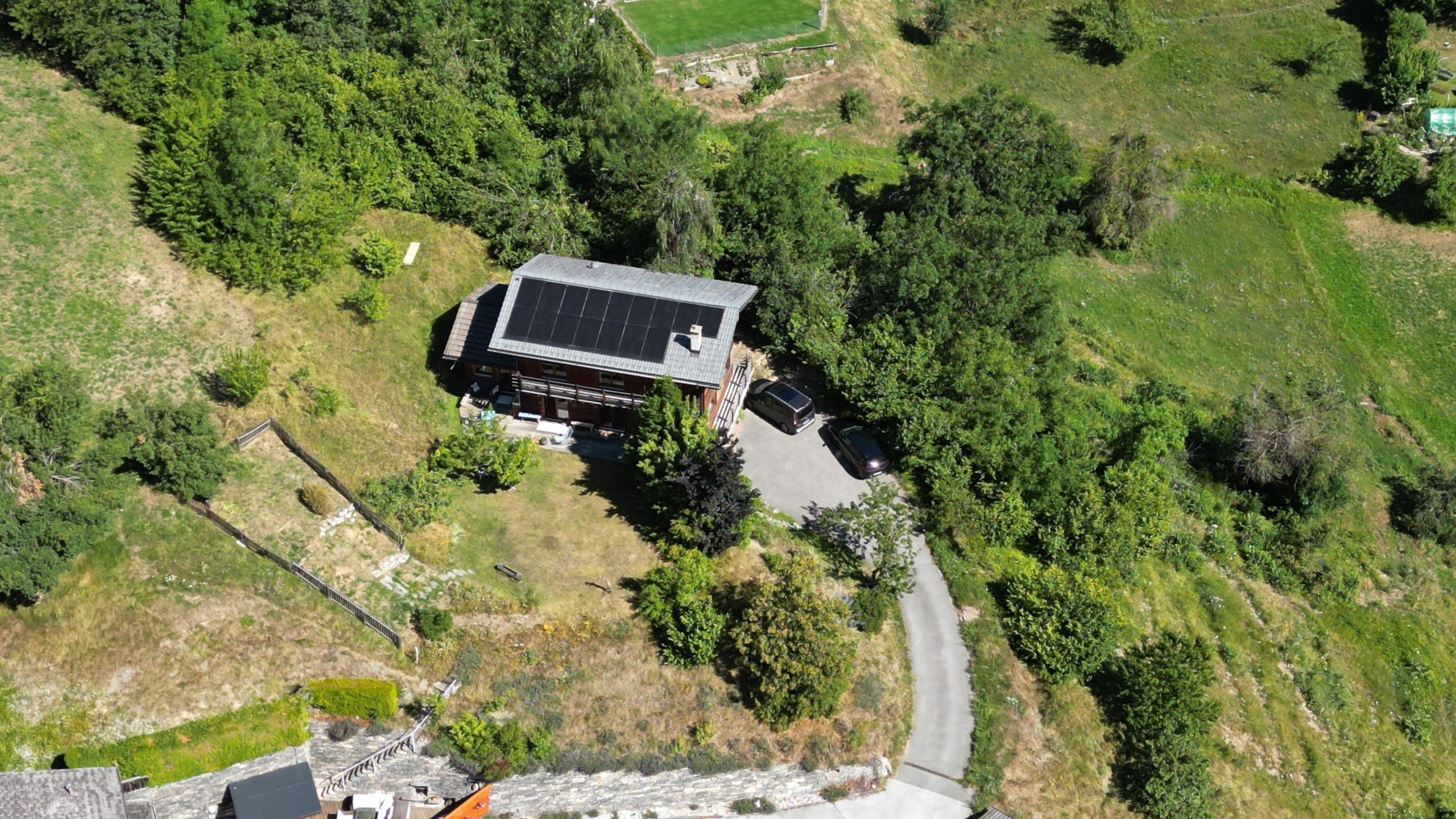 Luftaufnahme eines Hauses auf einem grünen Grundstück