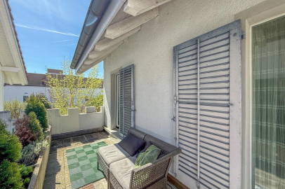Terrasse mit Sitzgelegenheit neben Hausfassade