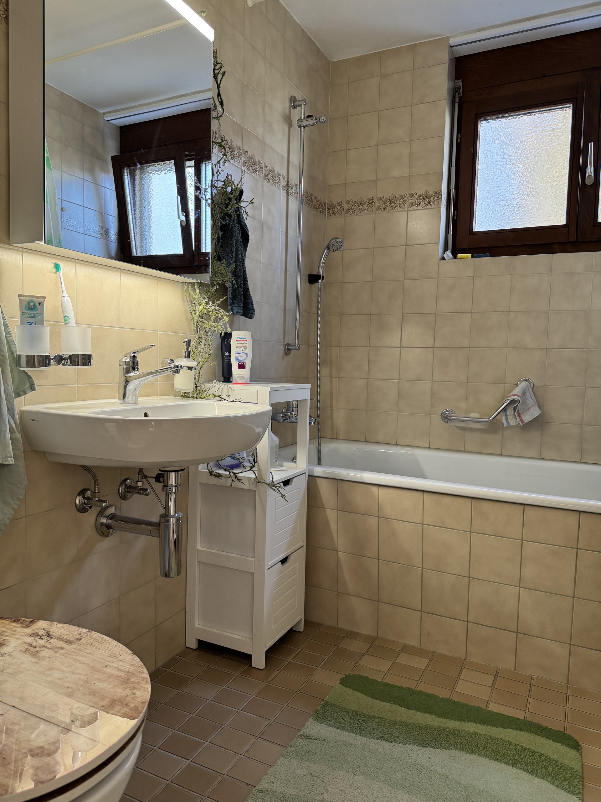 Badezimmer mit Badewanne und Waschplatz