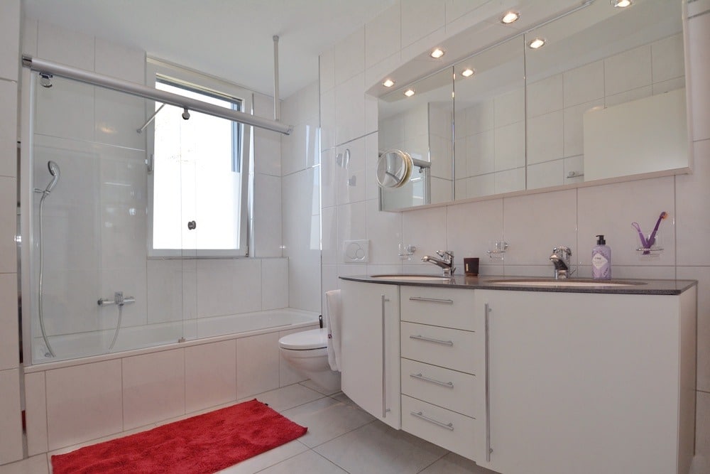 Helles, modernes Badezimmer mit Badewanne und Waschtisch