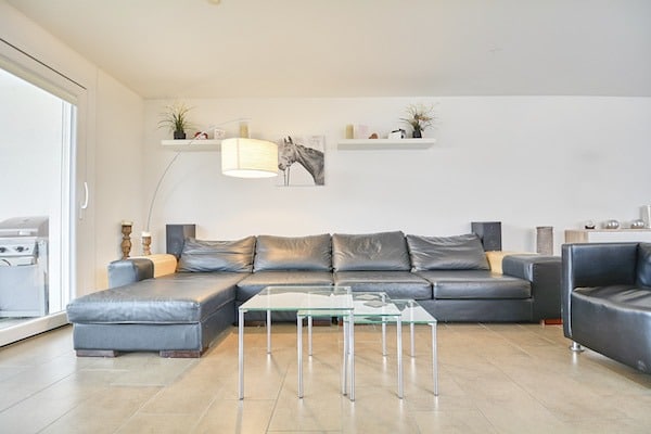 Modernes Wohnzimmer mit Ledersofa und Glastischen
