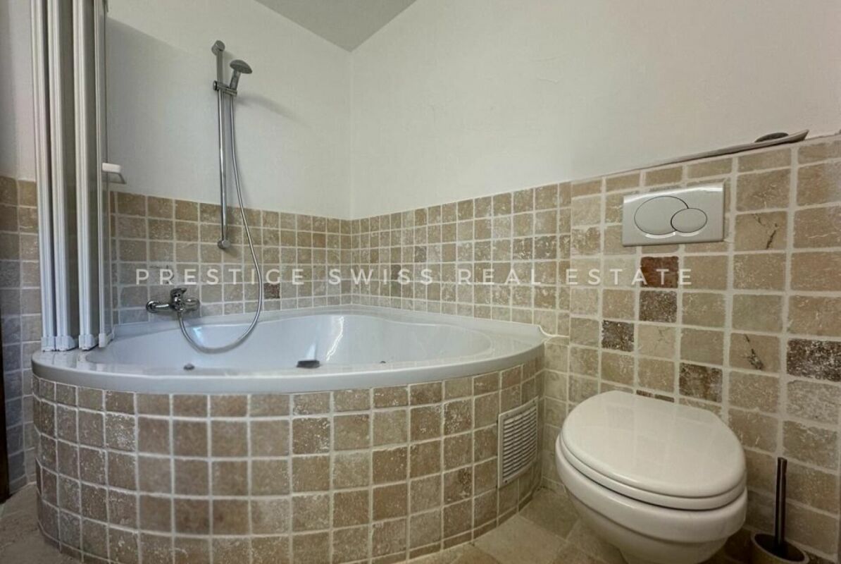 Badezimmer mit Eckwanne und WC