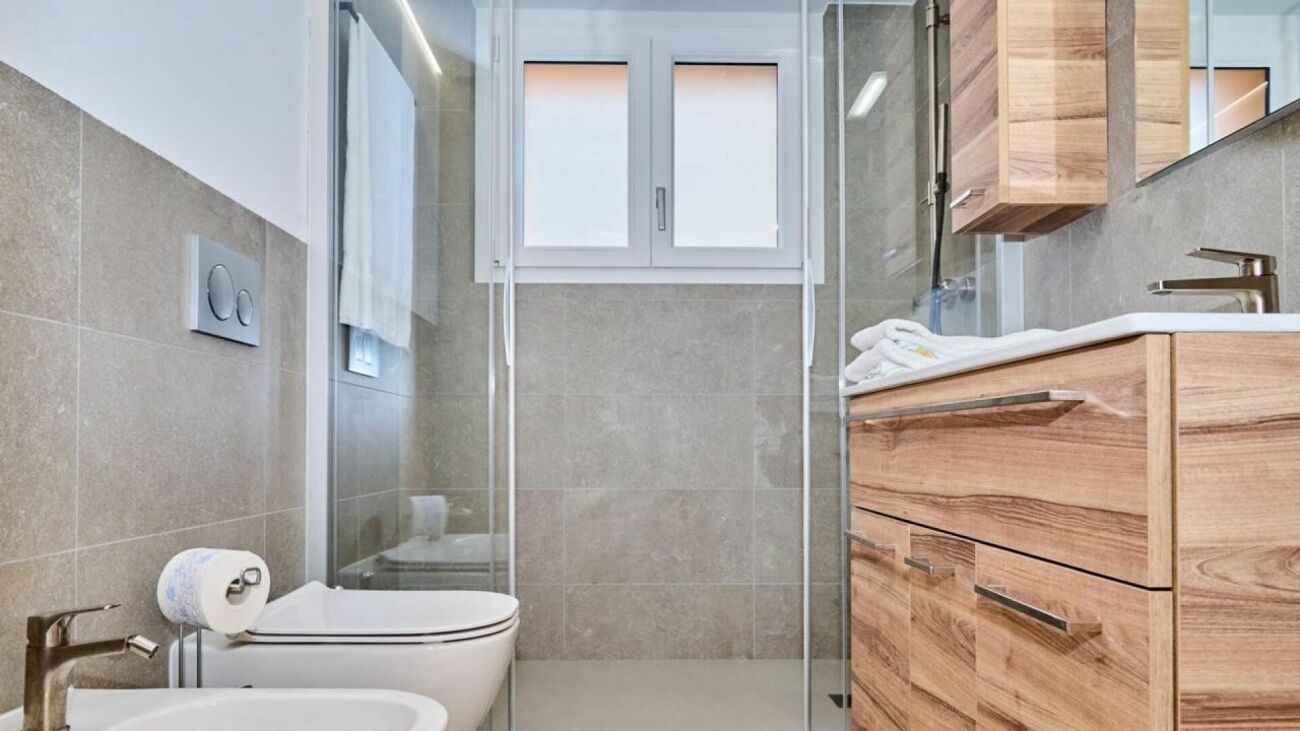 Modernes Badezimmer mit Dusche und Holzoptik-Möbeln