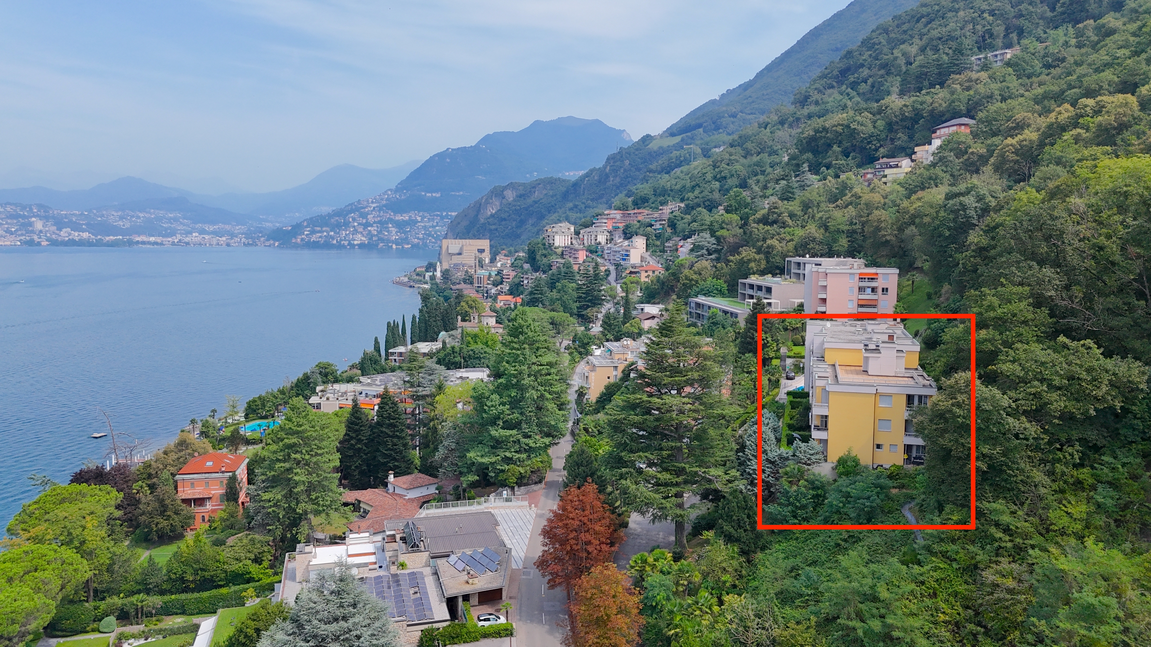 Luftaufnahme einer Villa am Hang mit Seeblick