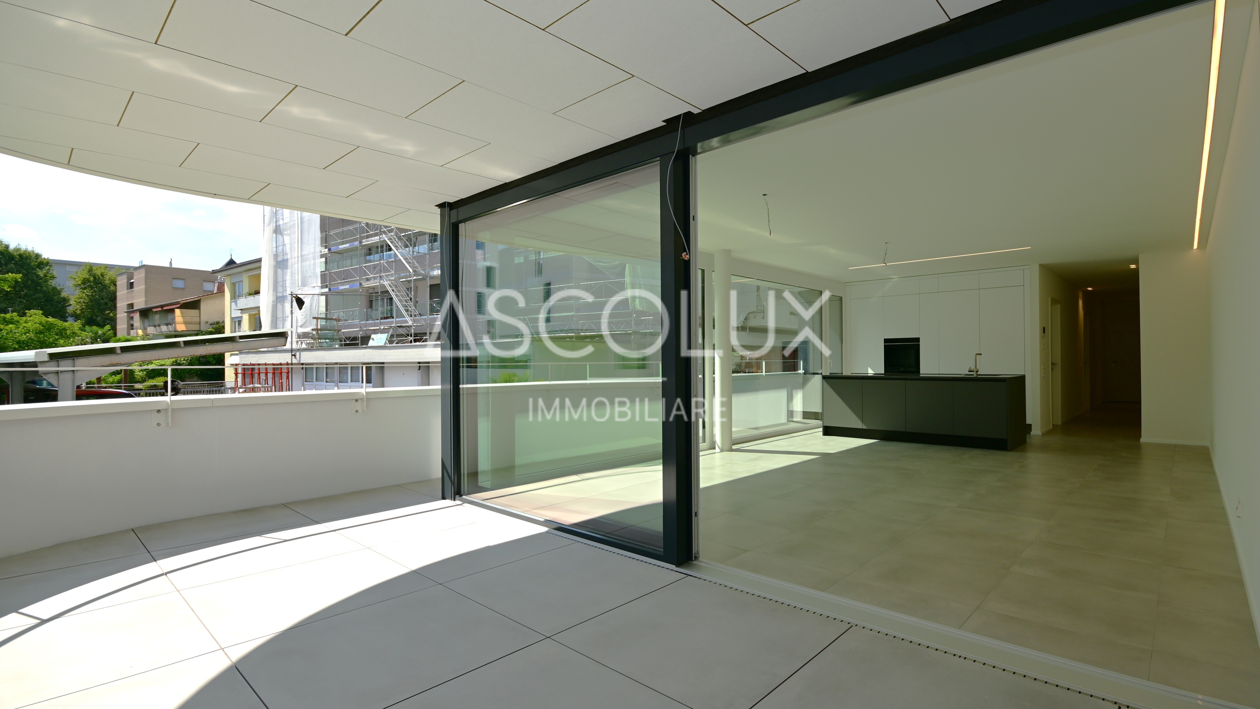 Große moderne Terrasse mit Blick in einen offenen Wohnbereich