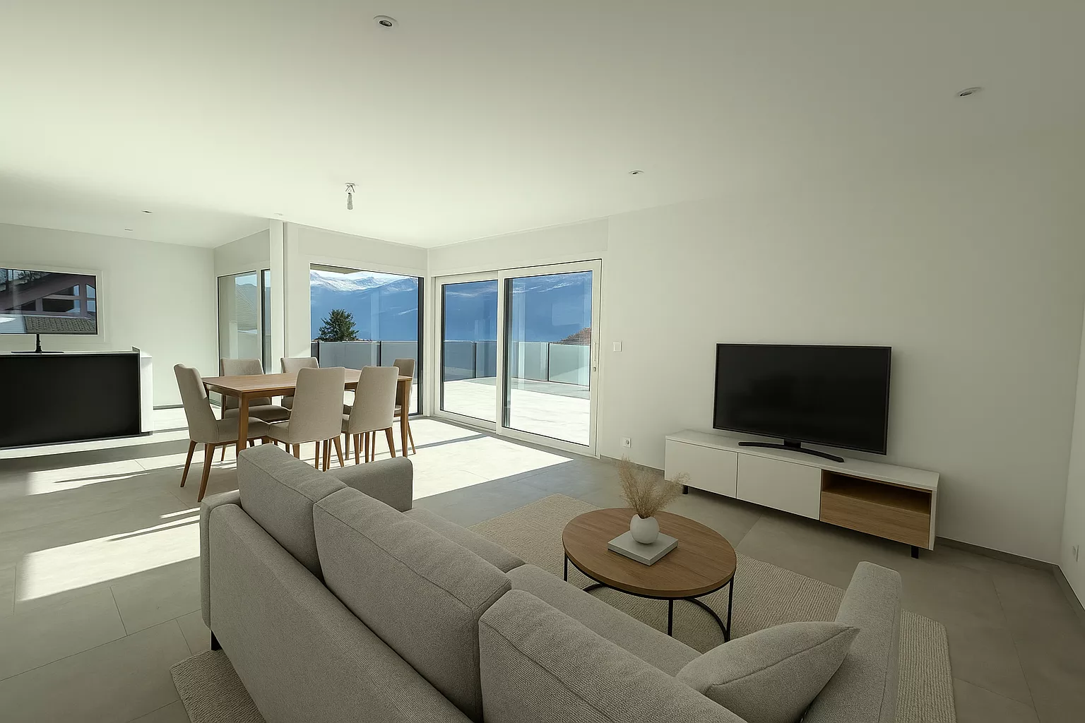 Modernes, helles Wohn-Esszimmer mit Terrasse und Bergblick
