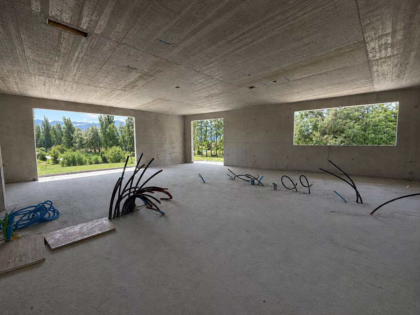 Rohbau mit großen Fensteröffnungen und Blick ins Grüne