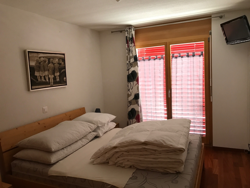 Schlafzimmer mit Doppelbett und Balkon-/Terrassentür