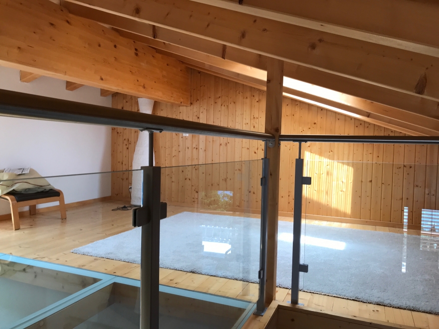 Holzgalerie mit Glasgeländer