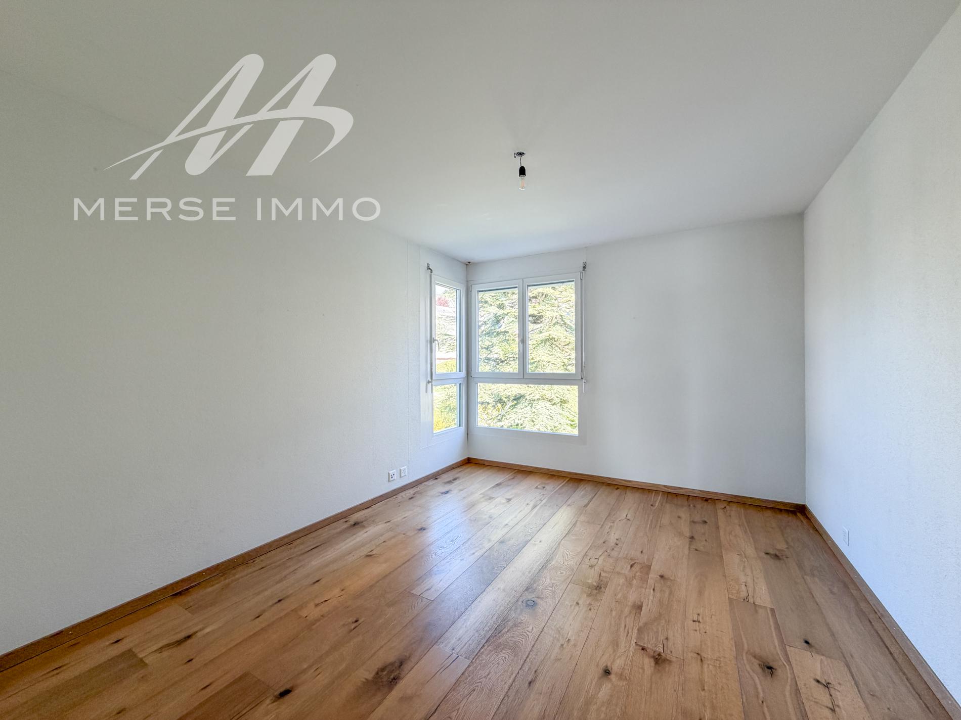 Helles leeres Zimmer mit Holzfußboden