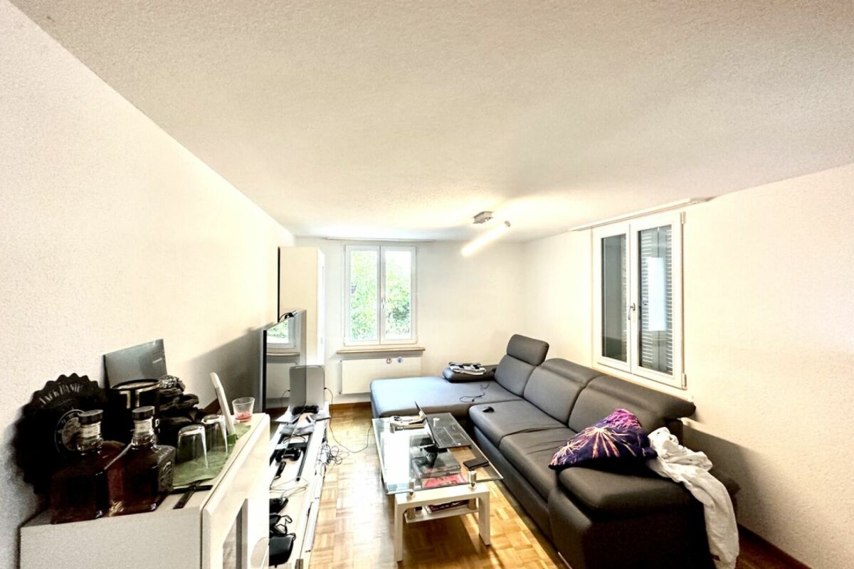 Wohnzimmer mit Sofa und Fensterfront