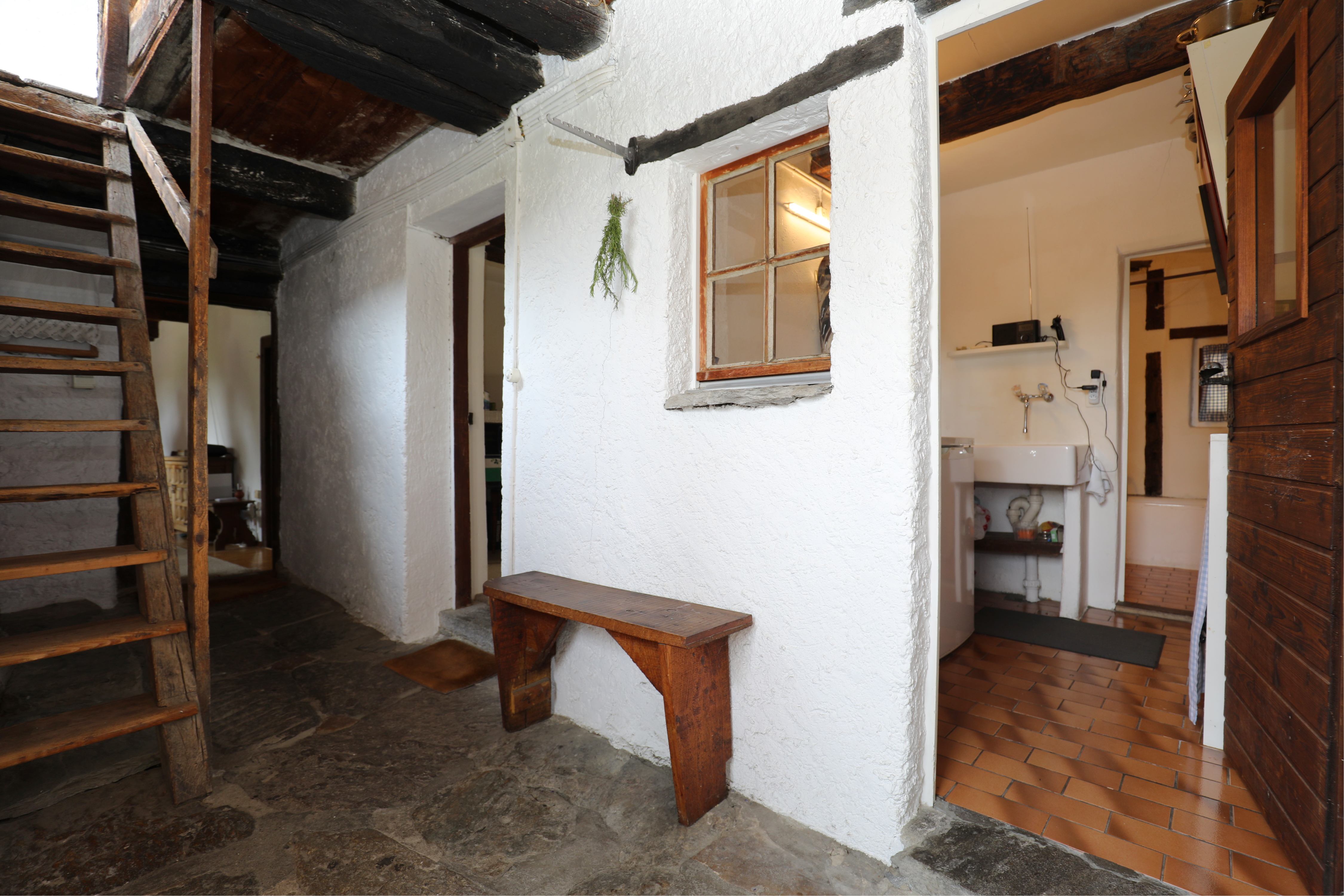 Rustikaler Innenbereich mit Treppe und Badzugang