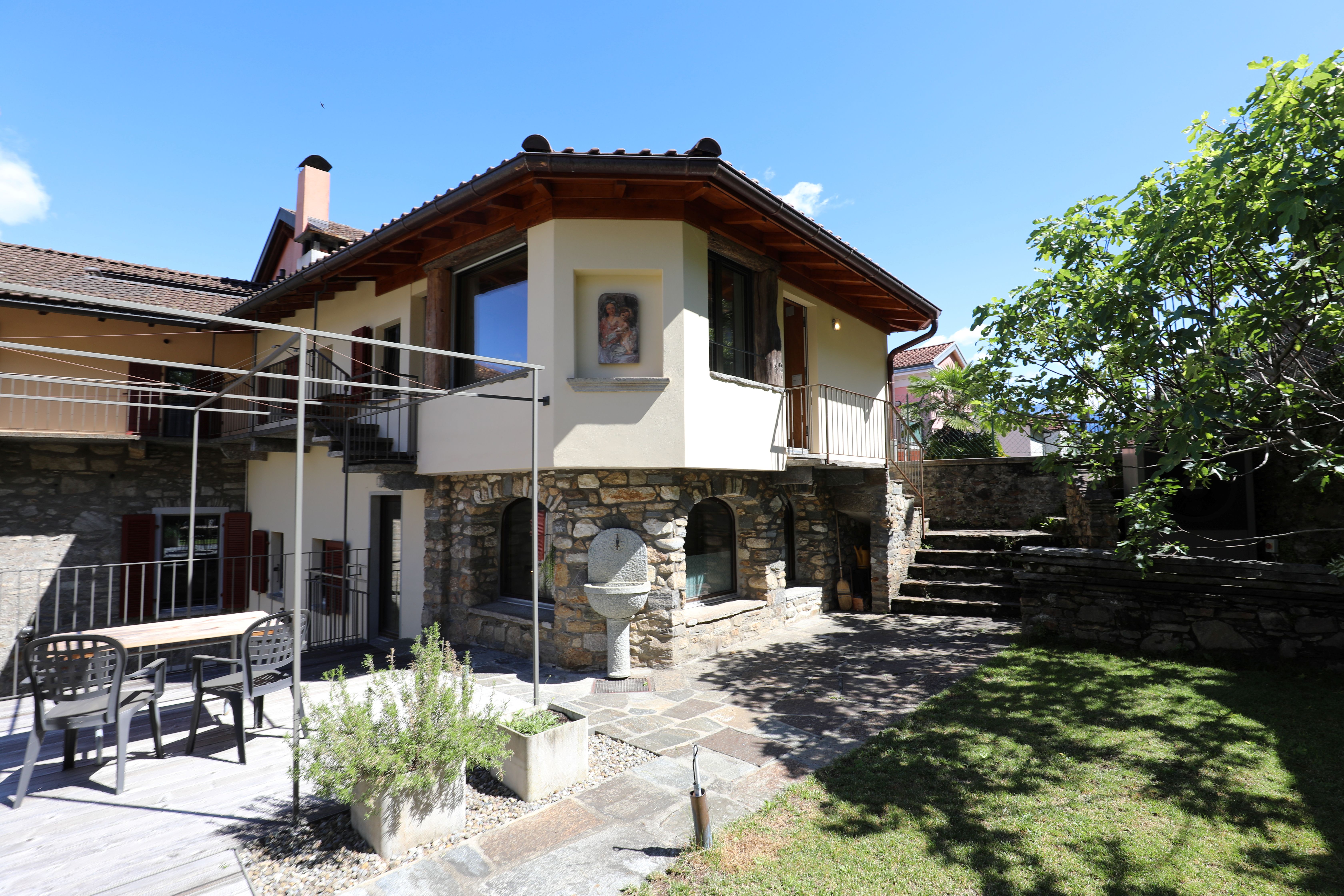Außenansicht eines mediterran wirkenden Wohnhauses mit Garten