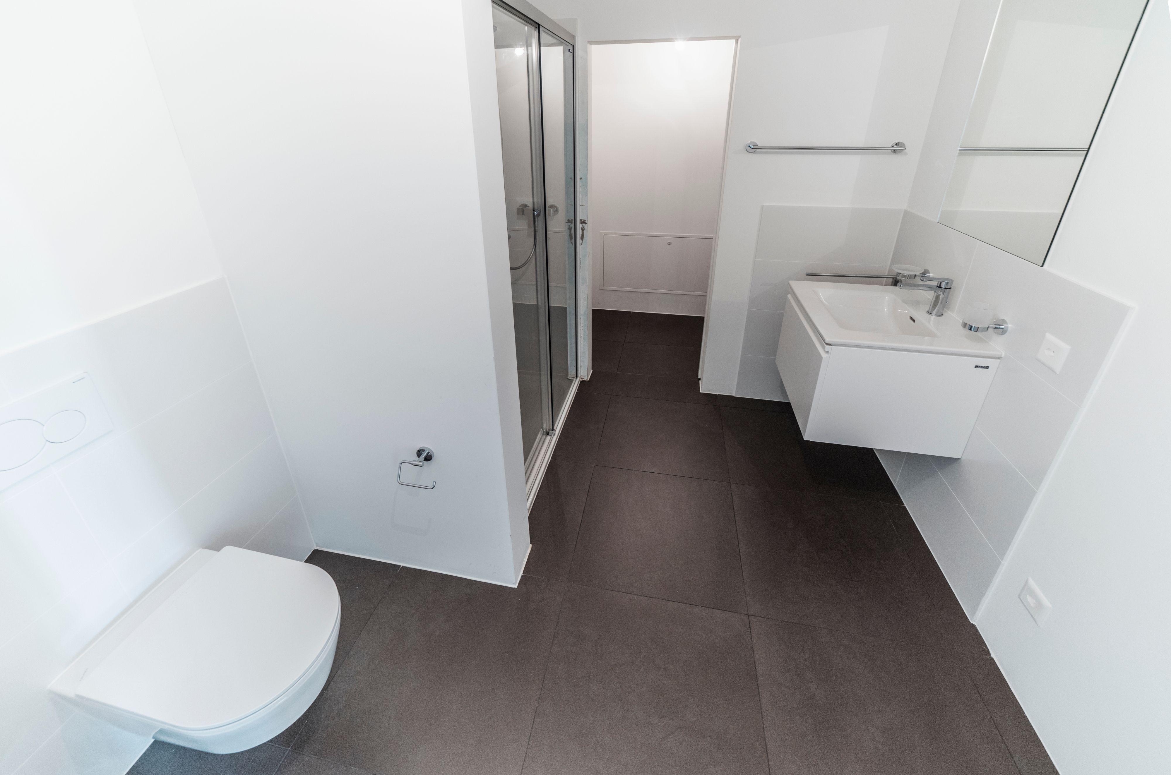 Modernes Badezimmer mit Dusche und wandhängendem WC