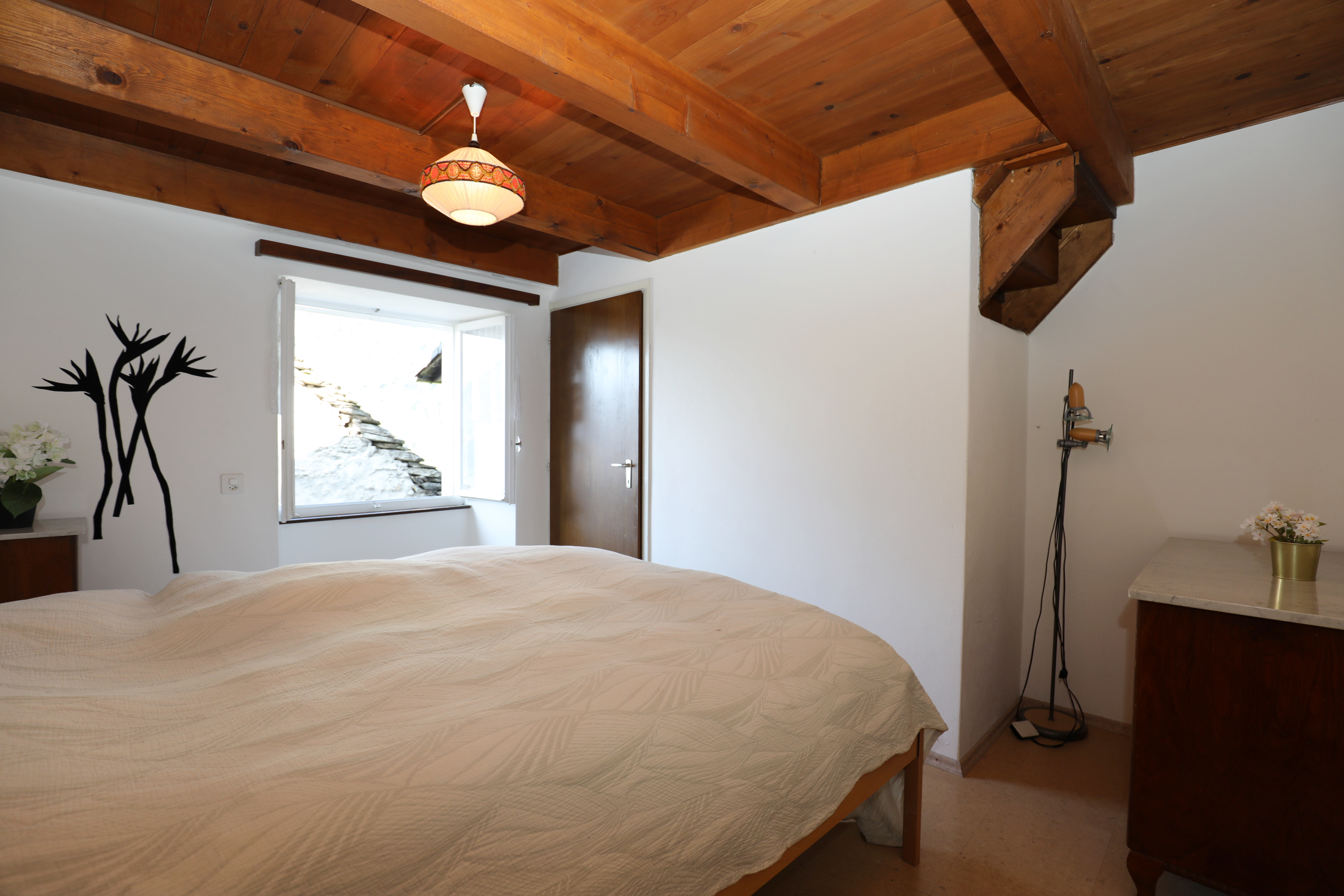 Schlafzimmer mit sichtbaren Holzbalken