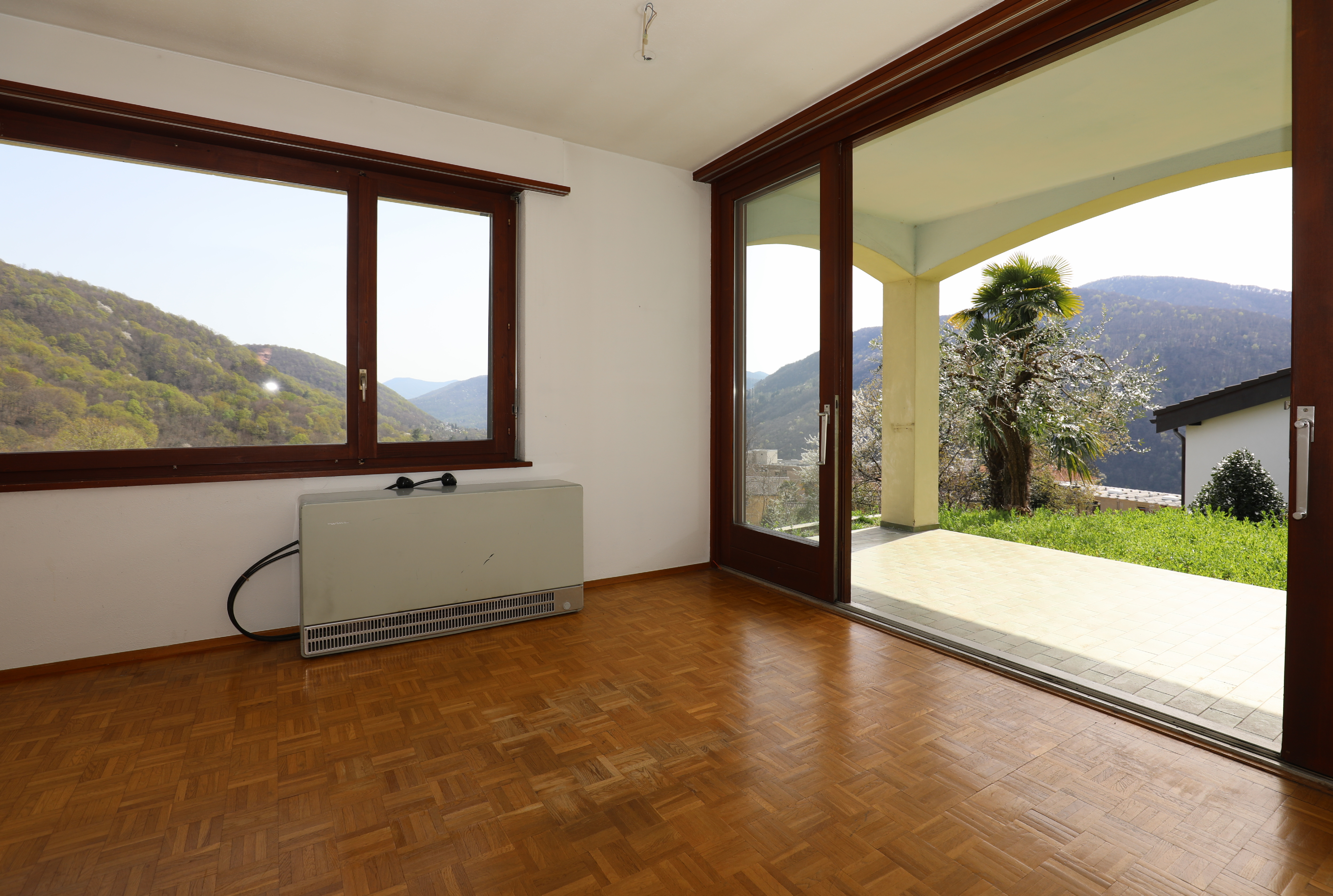 Wohnraum mit Balkonzugang und Bergblick