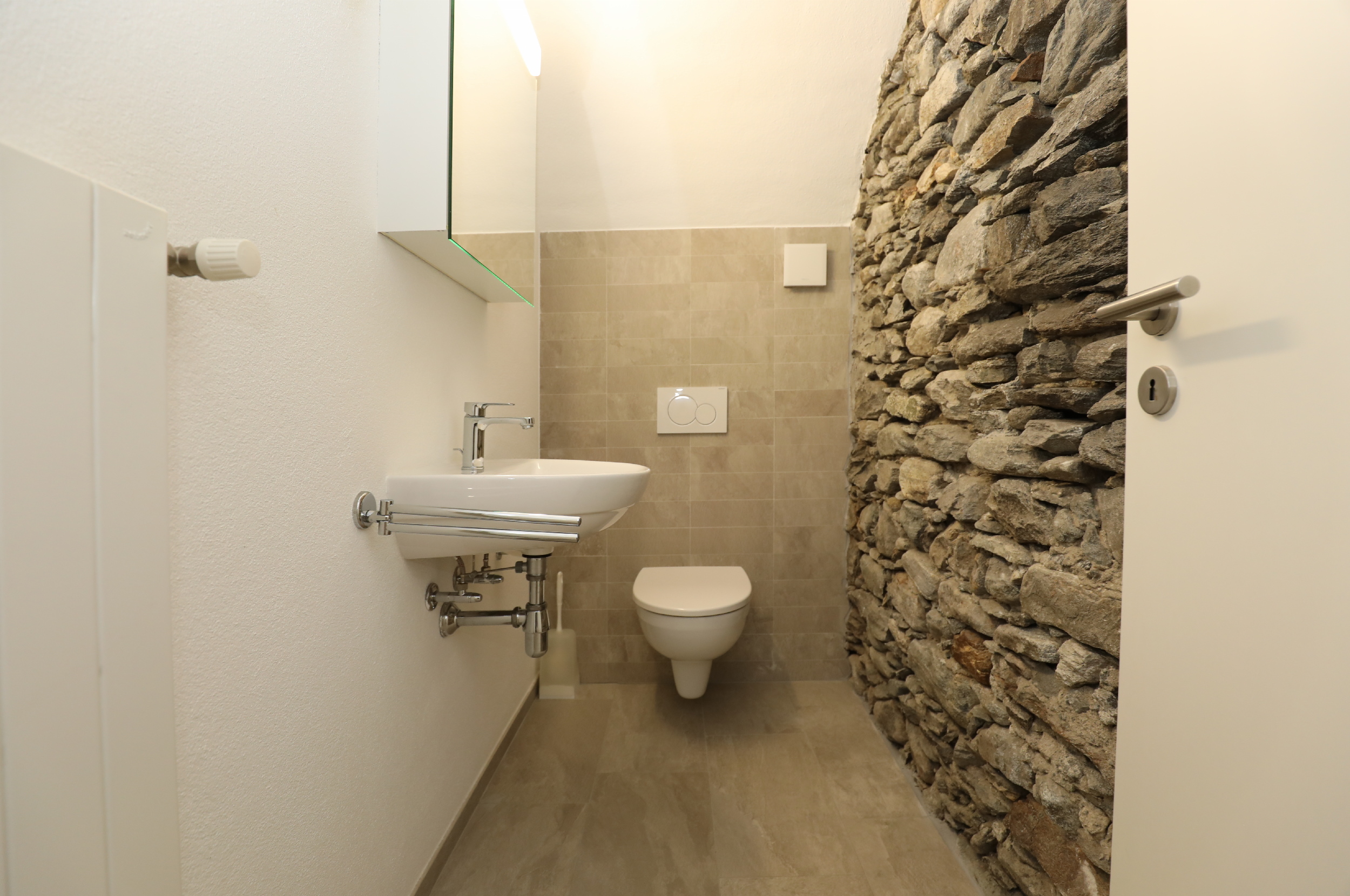 Kleines Gäste-WC mit Natursteinwand