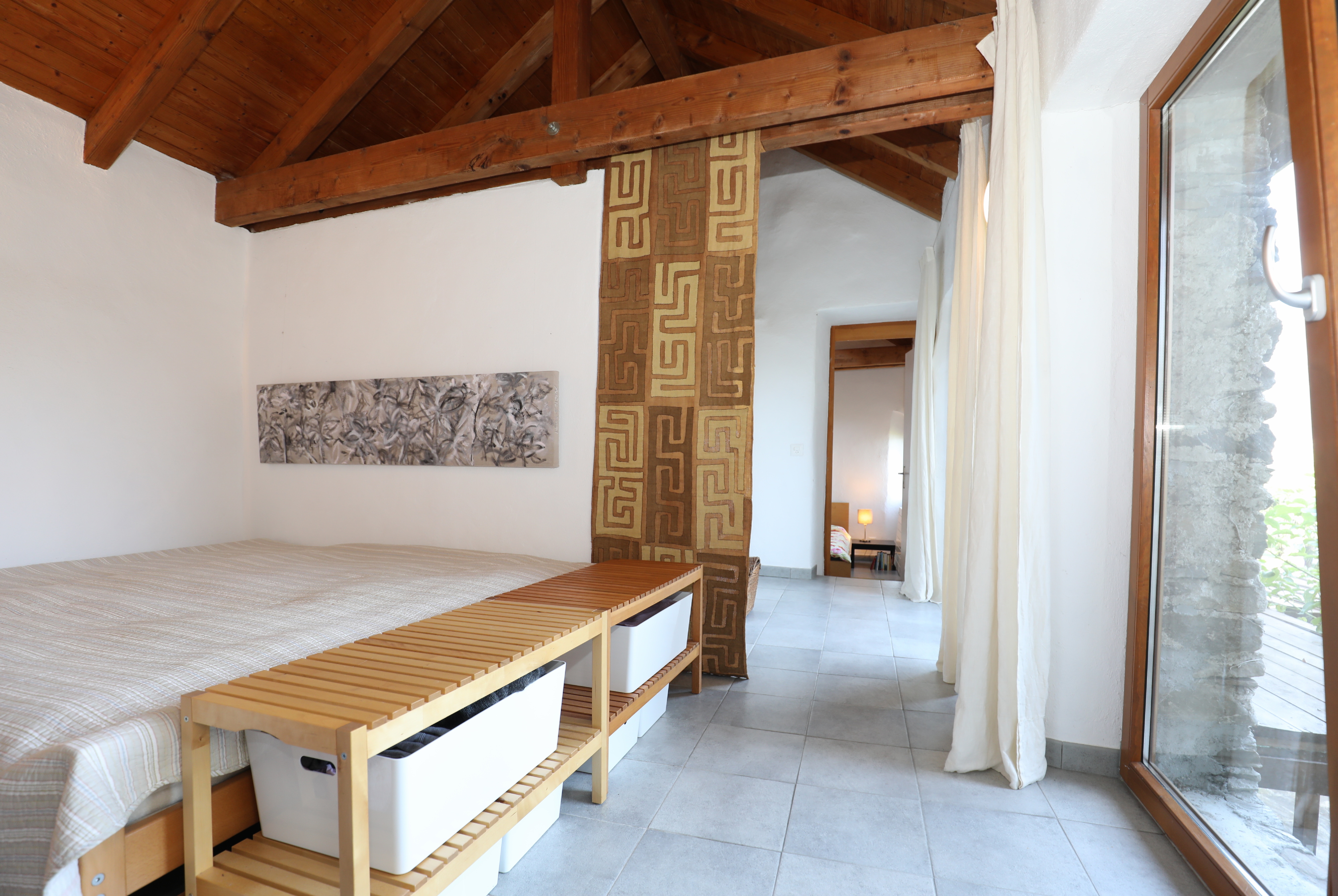 Helles Schlafzimmer mit sichtbaren Holzbalken