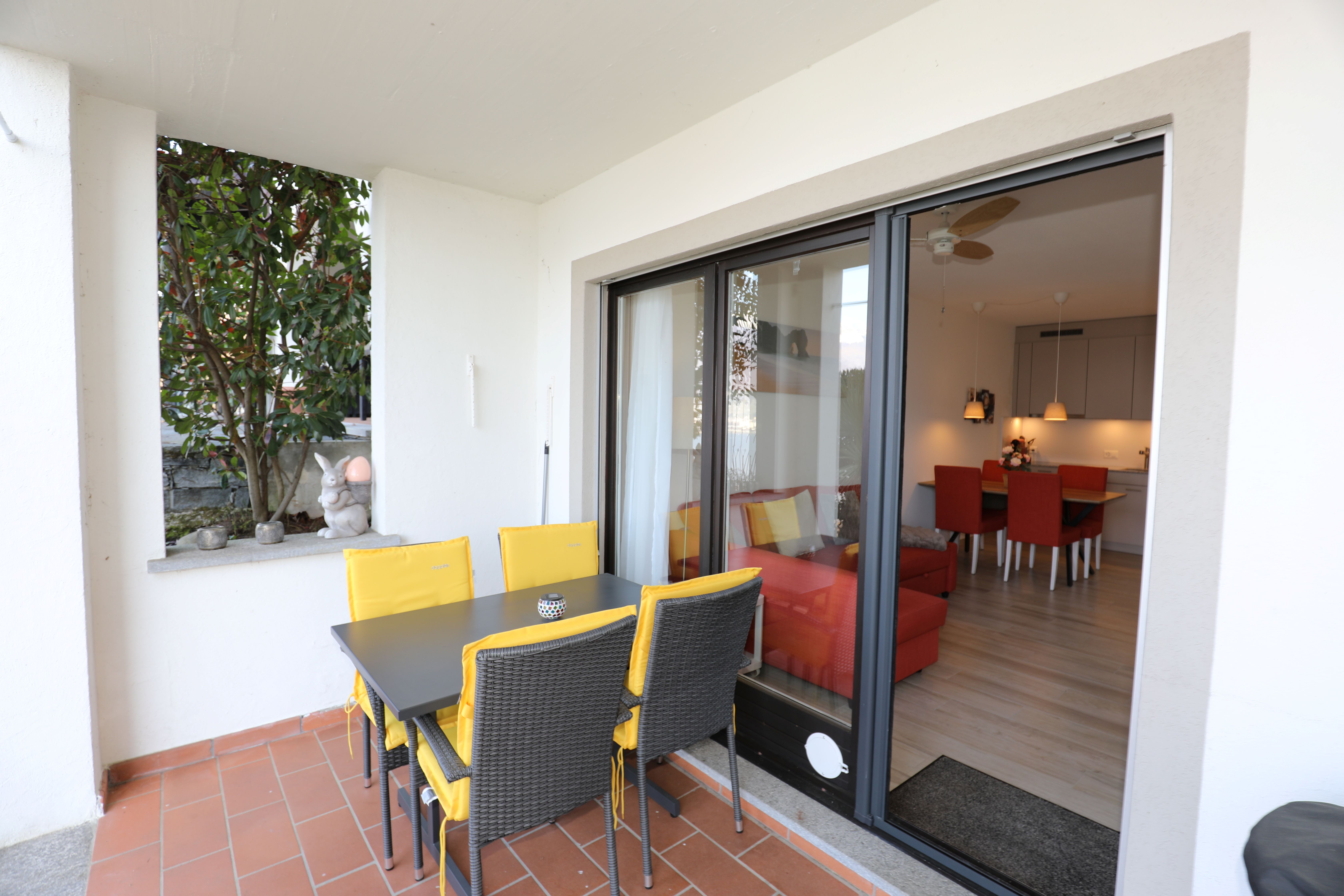 Überdachte Terrasse mit Blick ins Wohn-/Esszimmer
