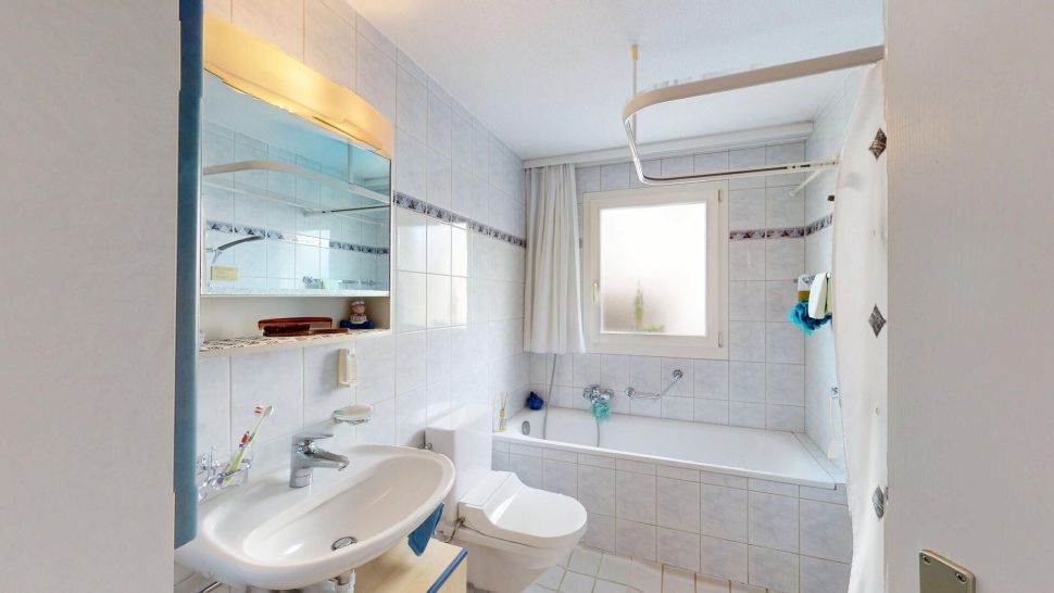 Helles Badezimmer mit Badewanne und Waschbecken