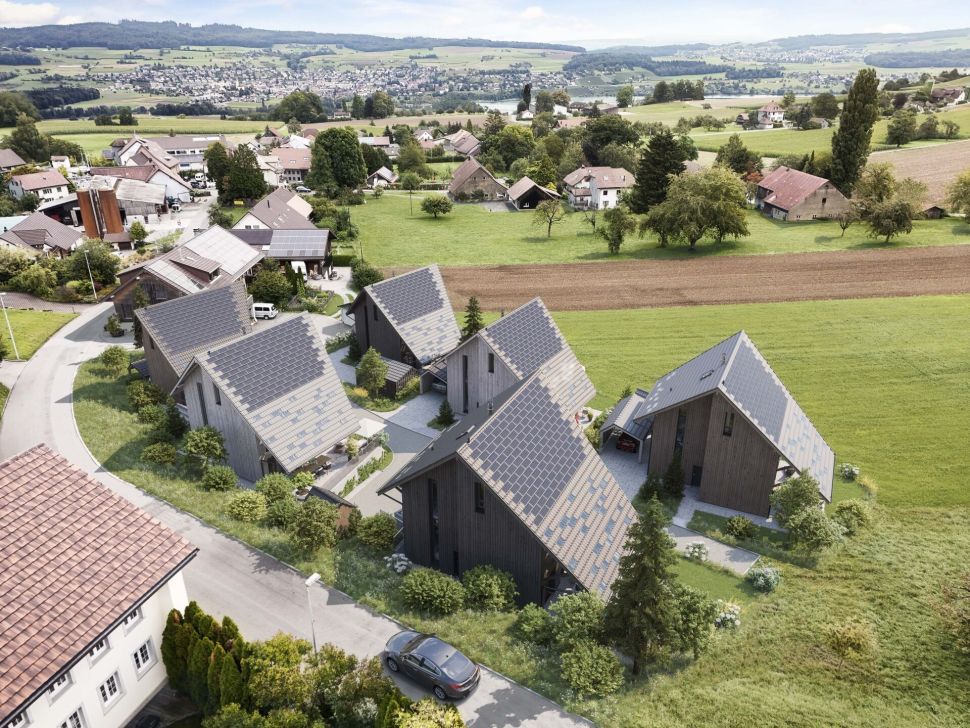Luftaufnahme eines modernen Wohnensembles in grüner Landschaft