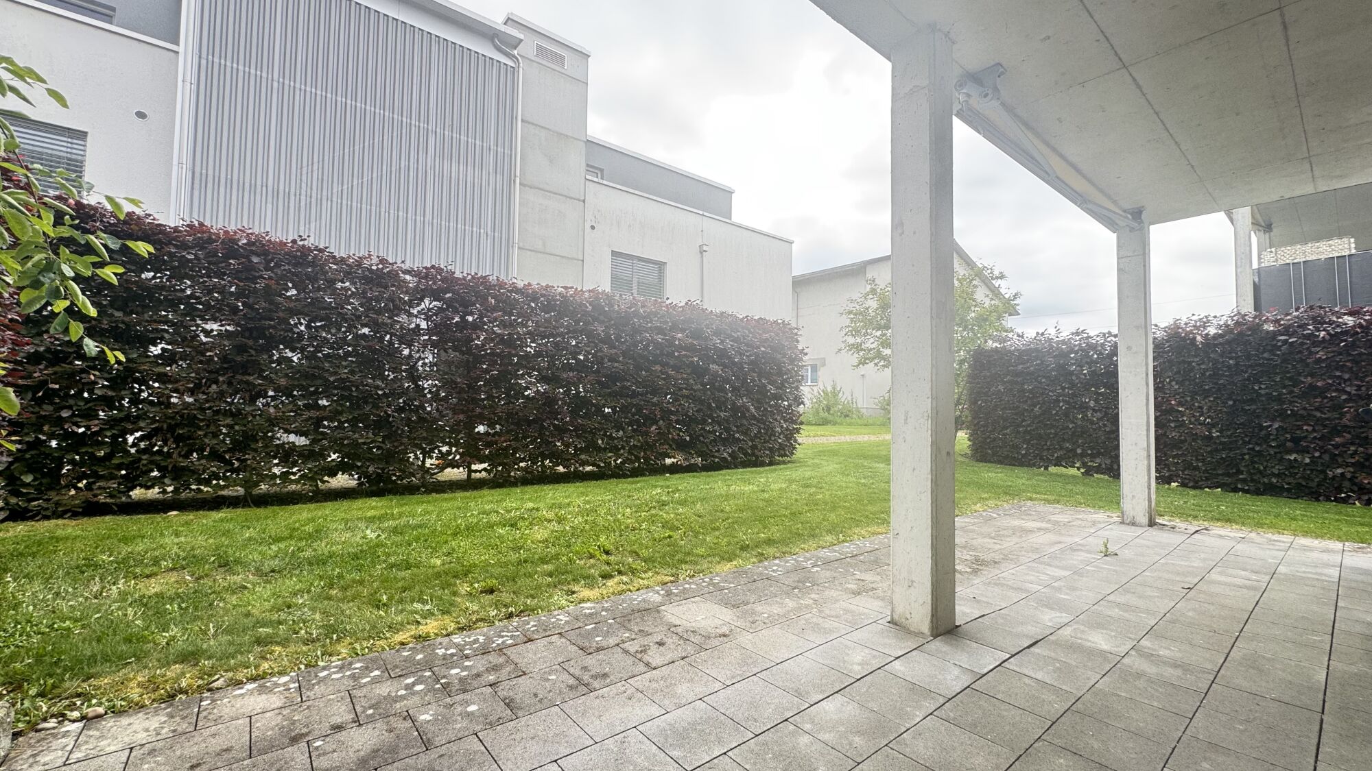 Überdachte Terrasse mit Gartenblick