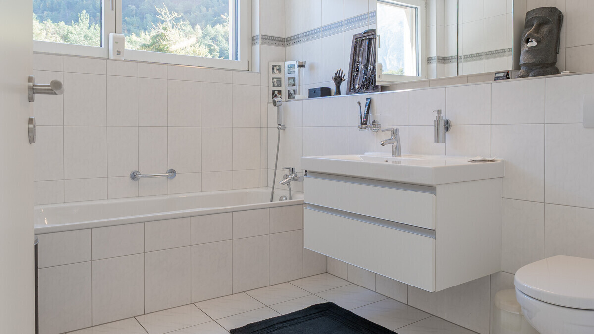 Helles Badezimmer mit Badewanne und Waschtisch