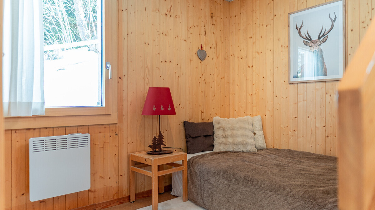 Gemütliches Schlafzimmer mit Holzvertäfelung