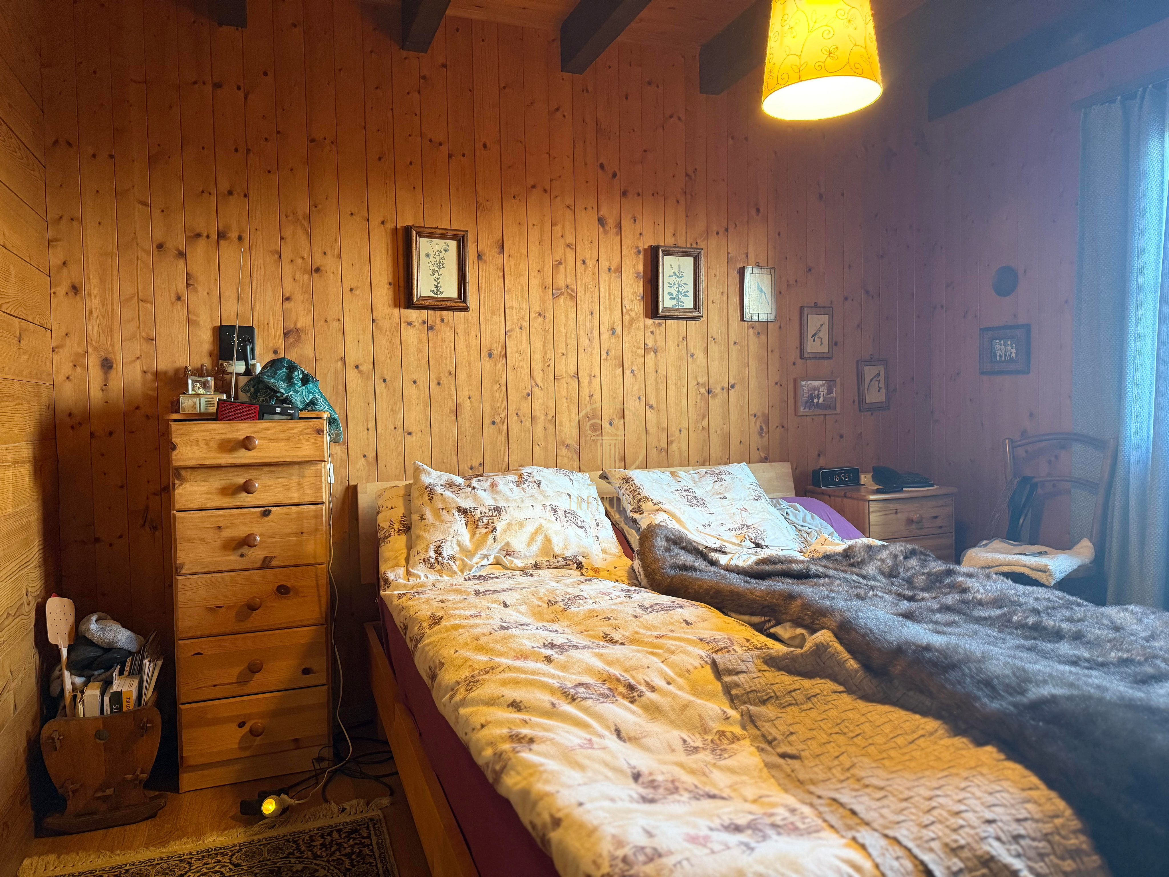 Gemütliches Schlafzimmer mit Holzvertäfelung