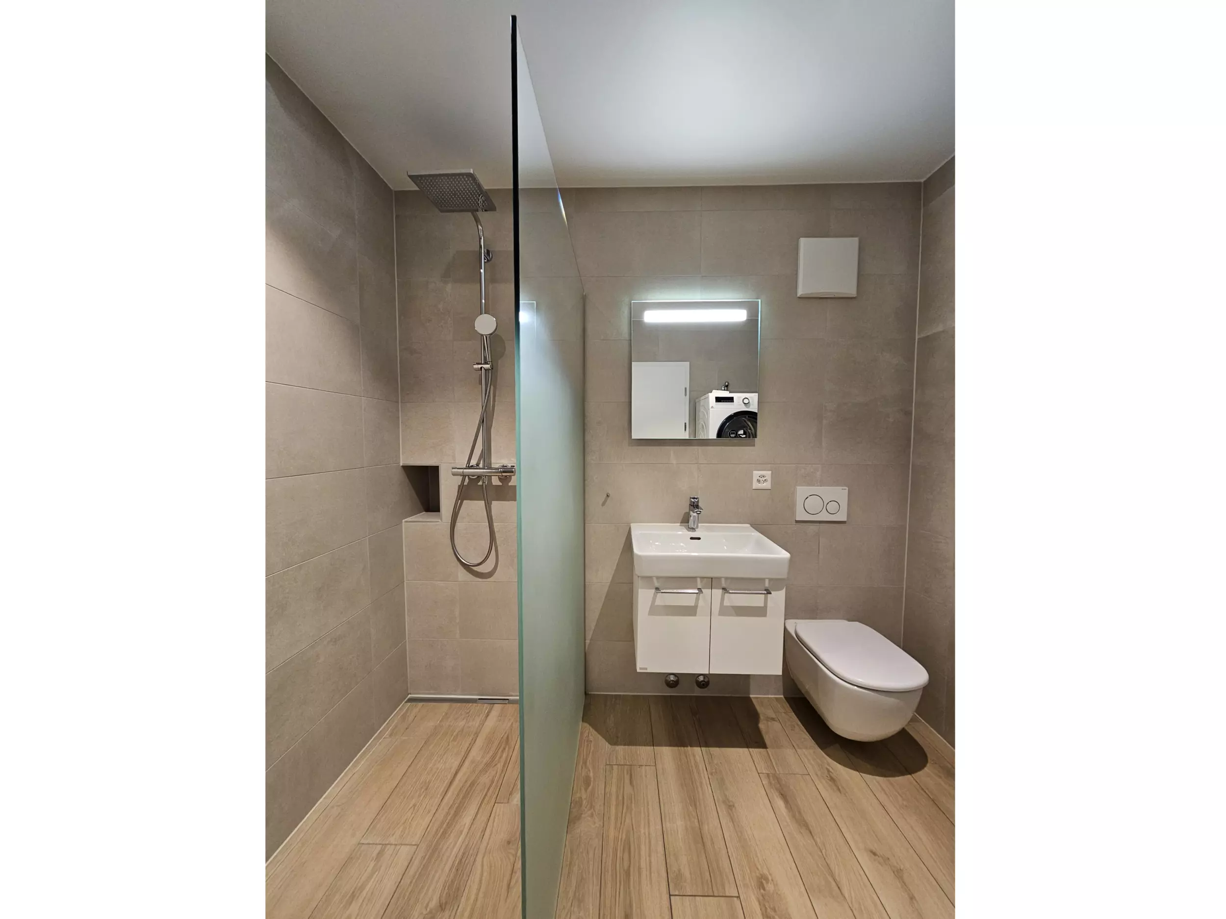Modernes Badezimmer mit bodengleicher Dusche, Waschtisch und wandhängendem WC