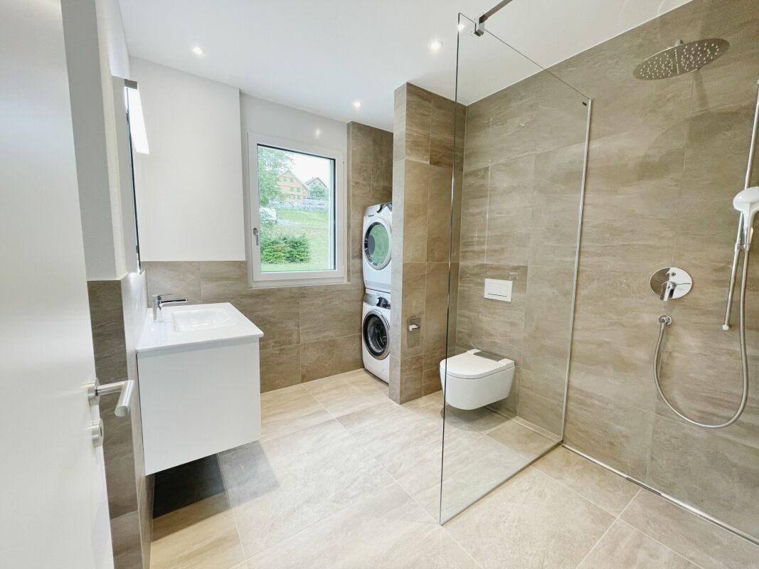 Modernes Badezimmer mit begehbarer Dusche und Hauswirtschaftsbereich