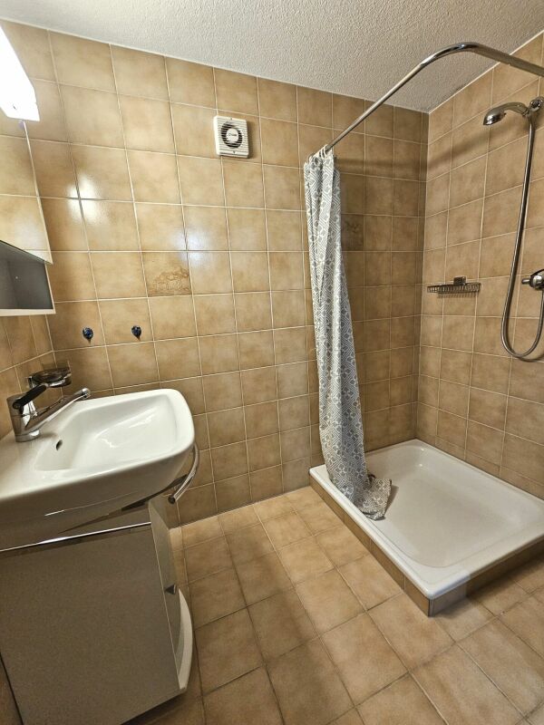 Badezimmer mit Dusche und Waschtisch