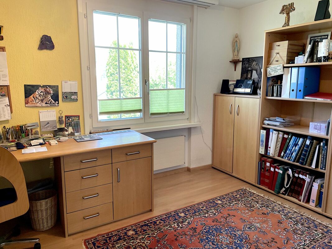 Arbeitszimmer mit Schreibtisch und Bücherregal
