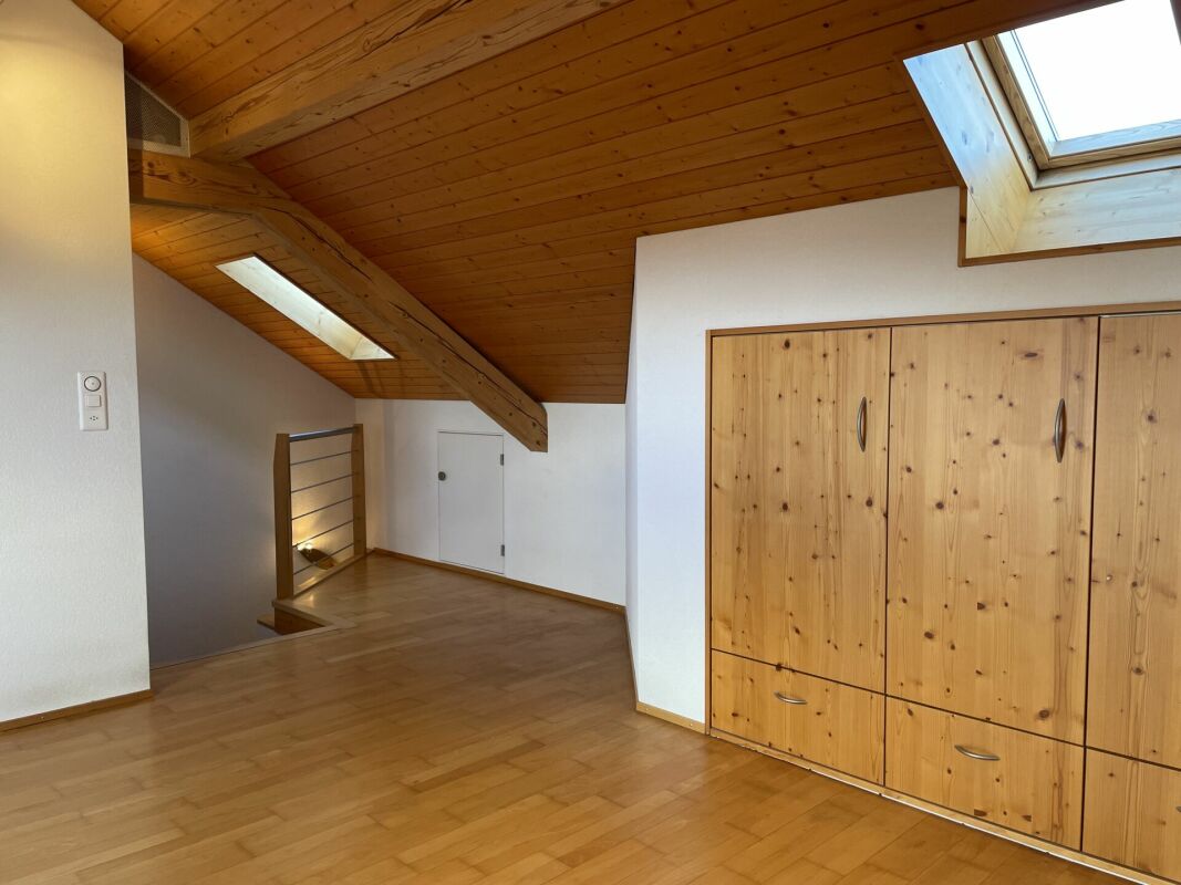 Dachgeschossraum mit Holzverkleidung und Einbauschrank