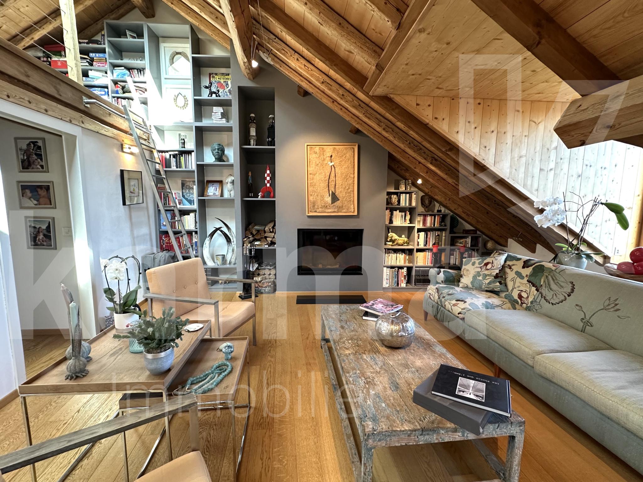 Dachgeschoss-Wohnzimmer mit Holzdeckenbalken