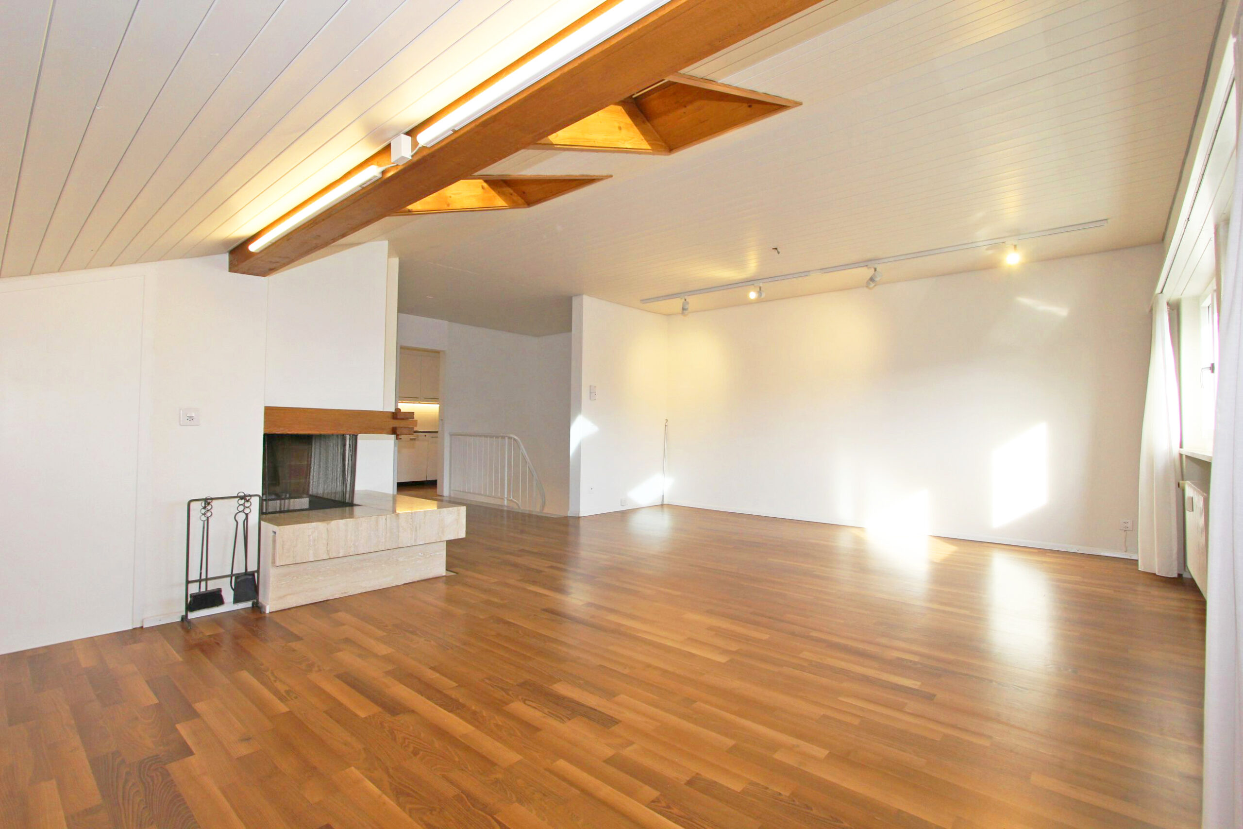 Heller Wohnraum mit Kamin und Holzboden