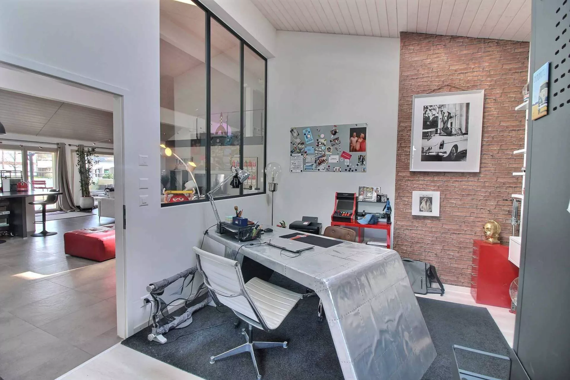Modernes Homeoffice mit Blick in einen offenen Wohnbereich
