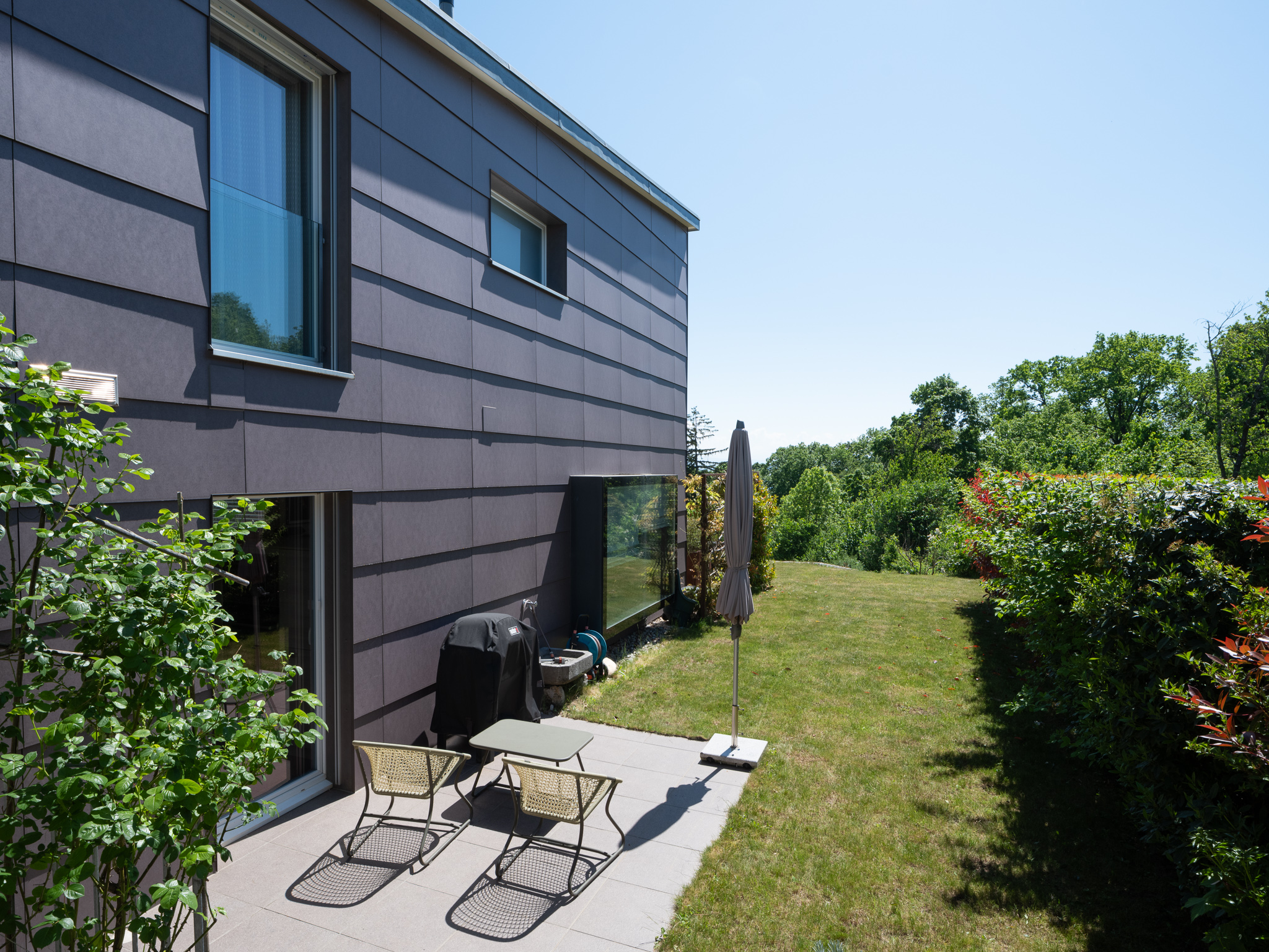 Moderne Hausfassade mit Garten und Terrasse