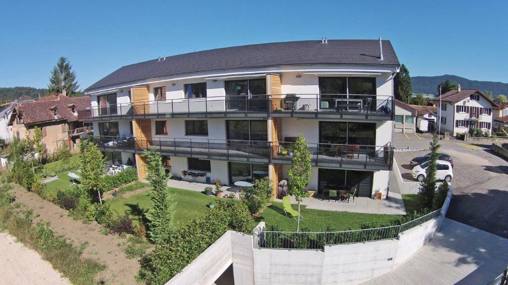 Mehrfamilienhaus mit Balkonen und Garten