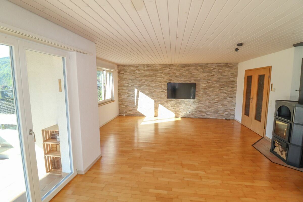 Heller Wohnraum mit Holzoptik und Kamin
