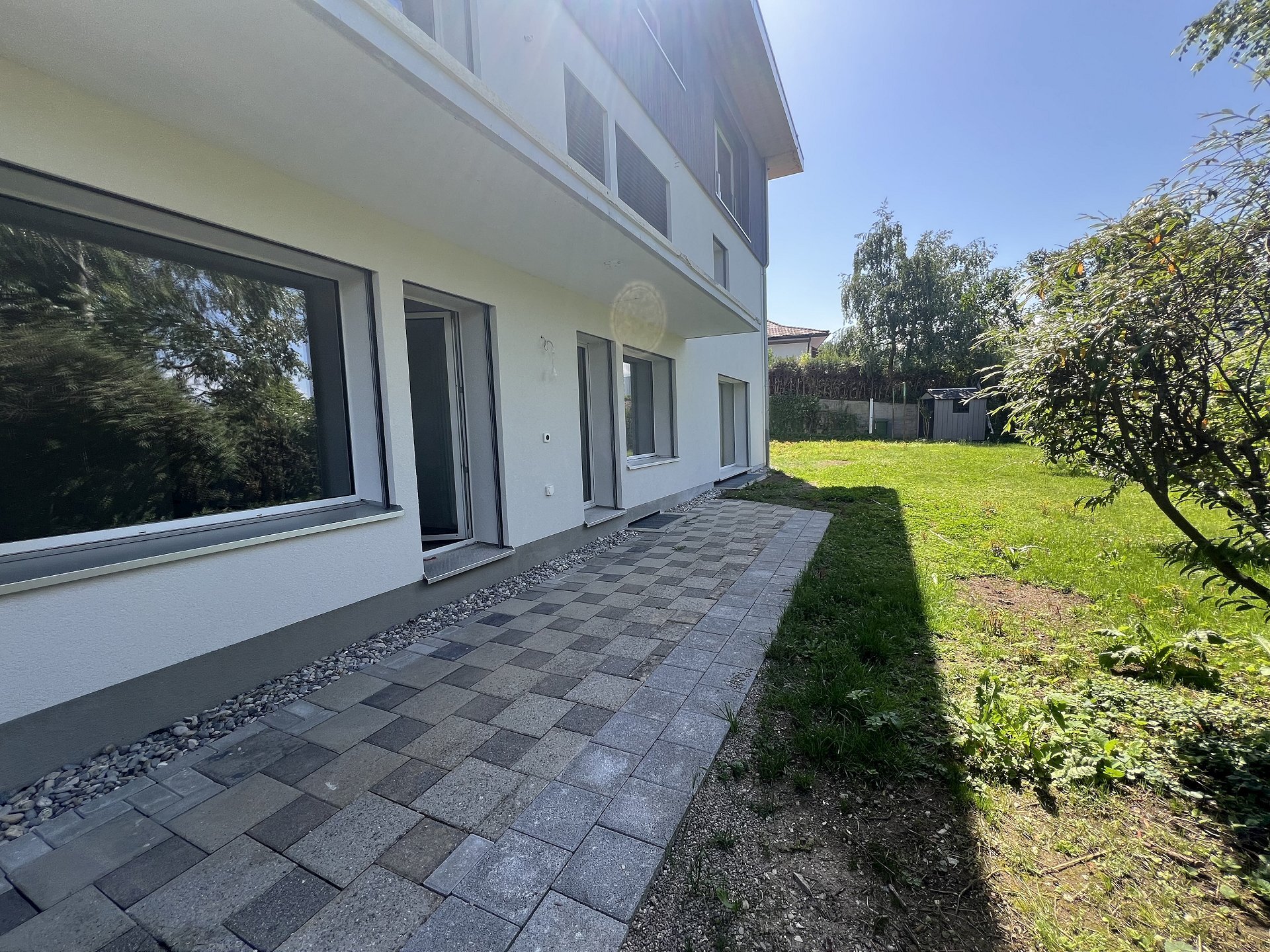 Moderne Hausfassade mit Garten und Terrassenweg